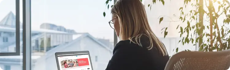 woman sitting and looking at a computer